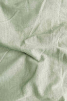 Close-up of light green fabric with folds