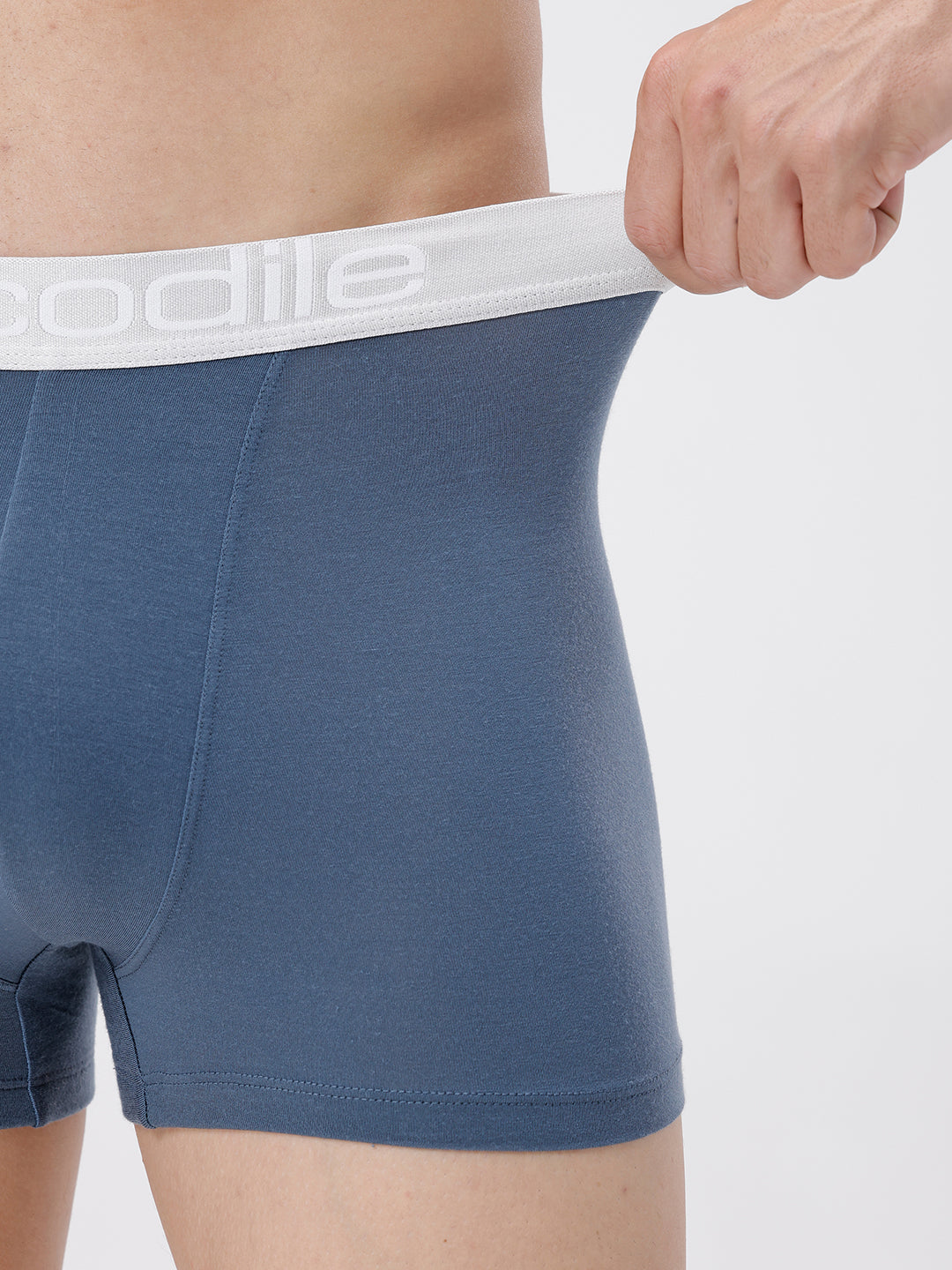 Blue boxer briefs with a white waistband featuring the brand name on a light gray background.