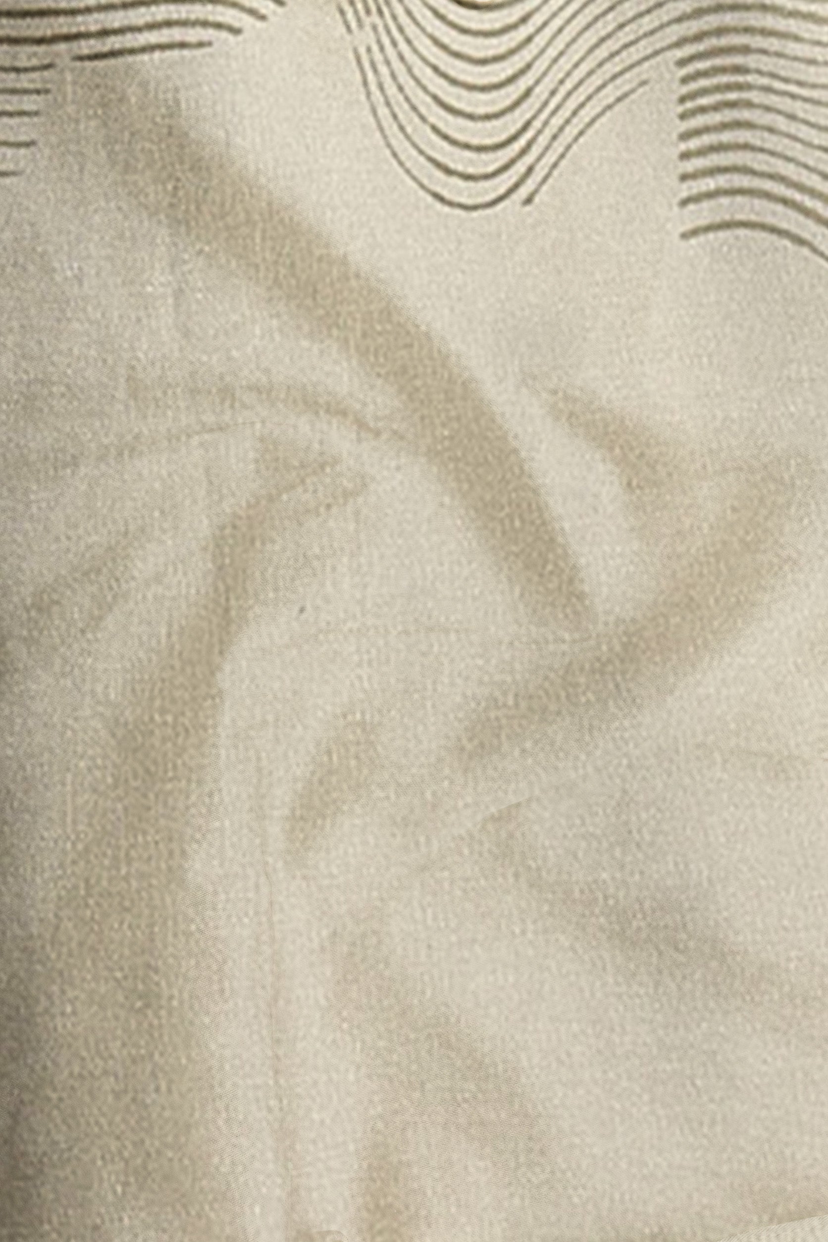 Close-up of beige fabric with subtle wave pattern