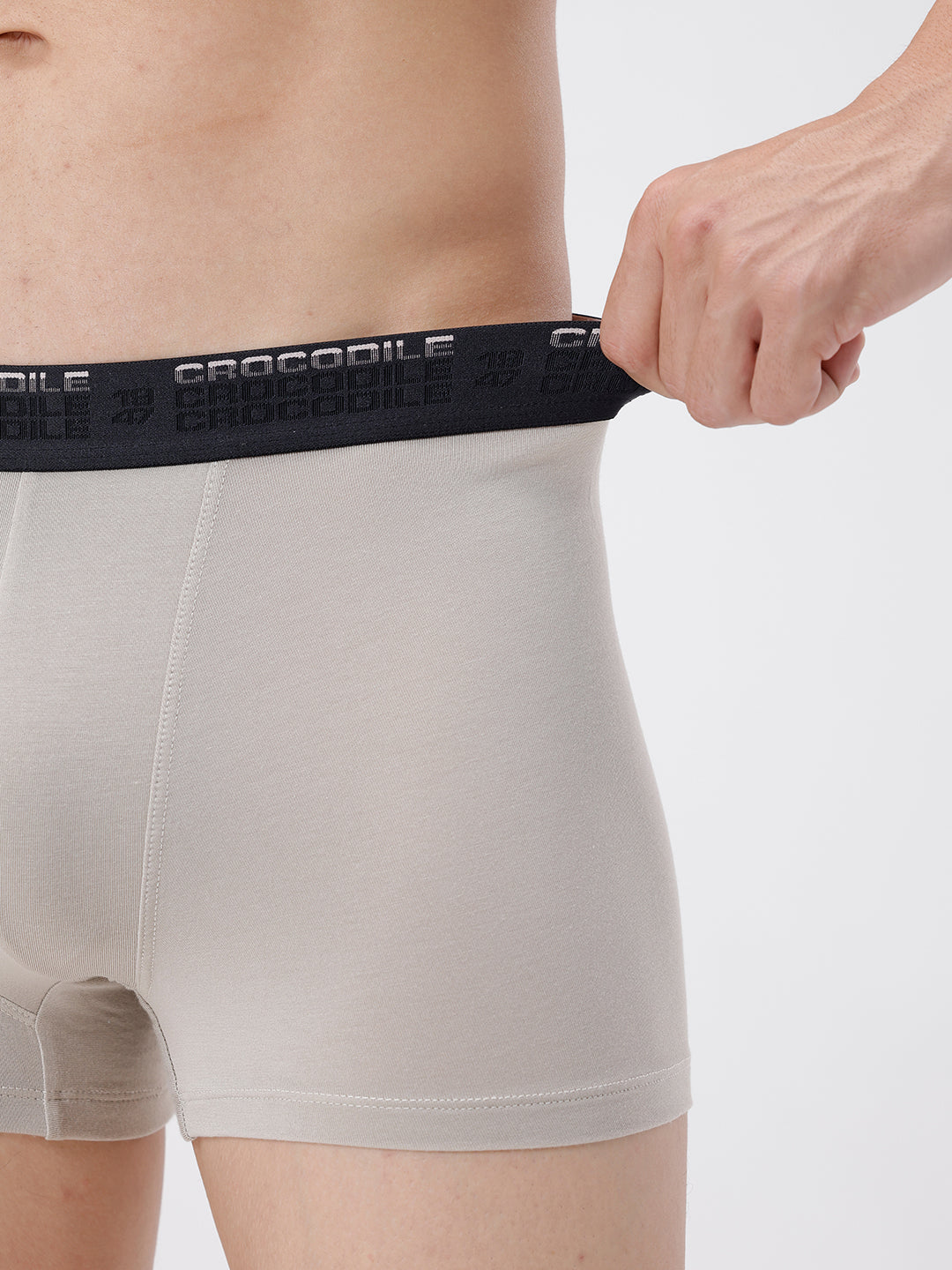 Person wearing light gray boxer briefs with a black waistband featuring 'Crocodile' branding.