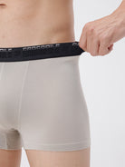 Person wearing light gray boxer briefs with a black waistband featuring 'Crocodile' branding.