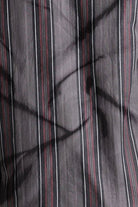 Close-up of striped fabric with dark and light vertical lines.