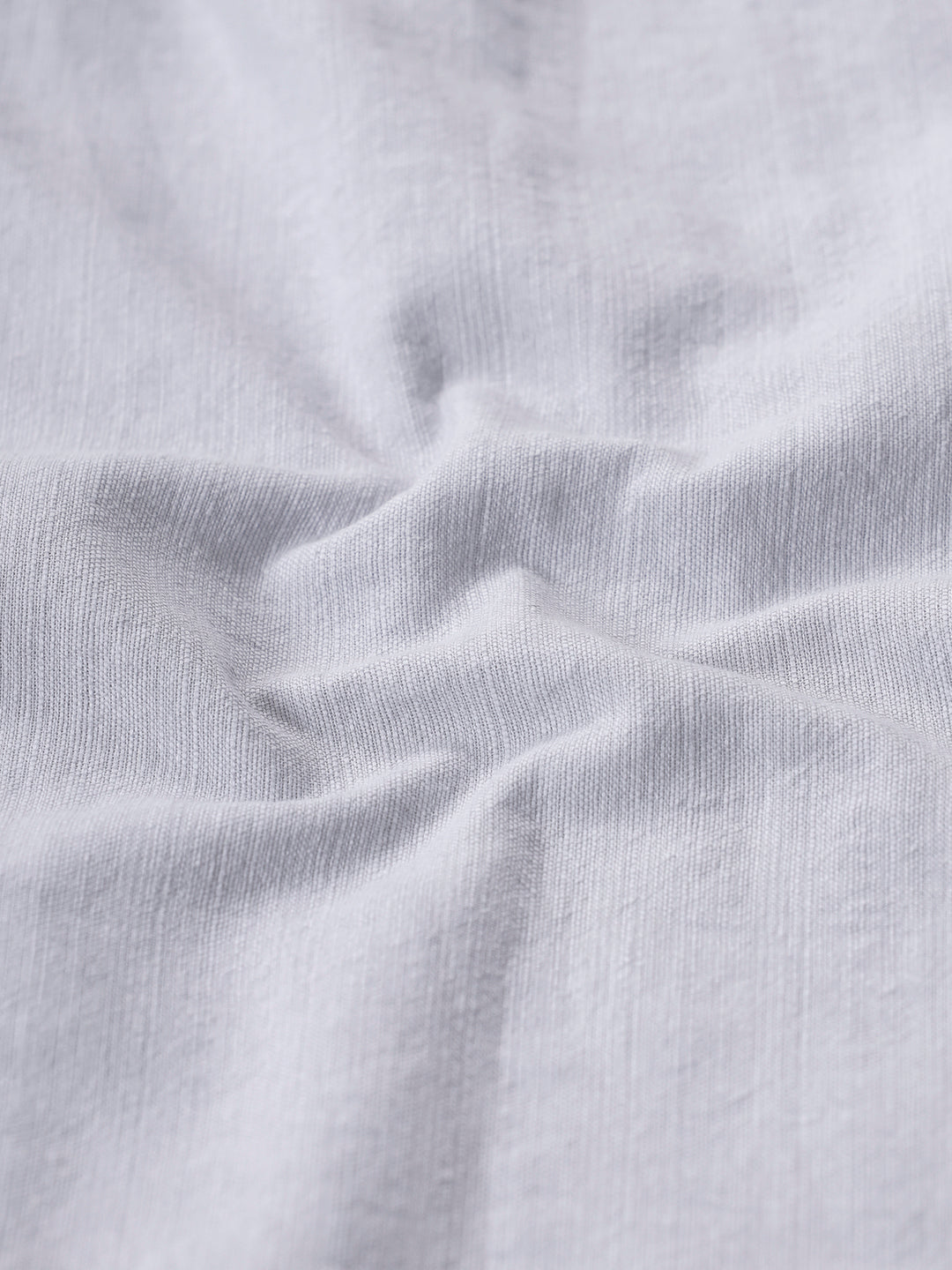 Man wearing a grey rib textured cotton shirt grey on a light gray background