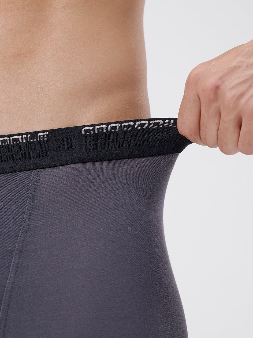 Person wearing a dark gray athletic outfit with a black waistband featuring 'Crocodile' branding.