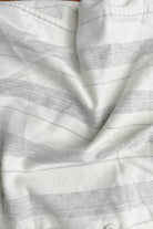 Close-up of white fabric with subtle gray stripes