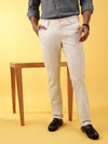 Man wearing a beige light beige solid slim fit casual trouser with casual styling on a gray background