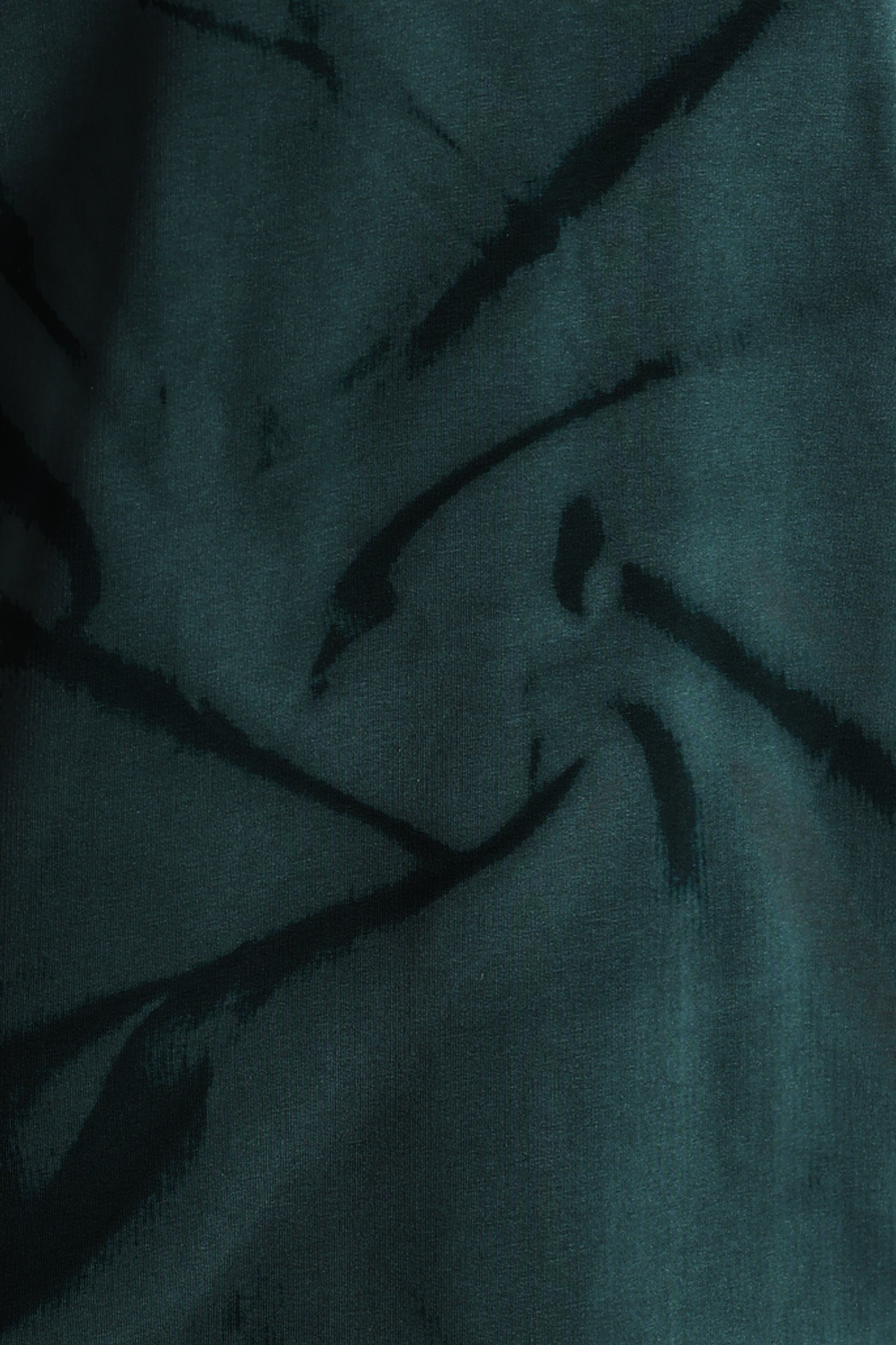 Dark fabric with feather-like patterns