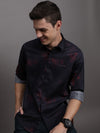 Man wearing a black casual black printed full sleeve 100% cotton shirt on a light gray background