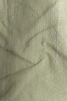 Close-up of green fabric with a textured pattern