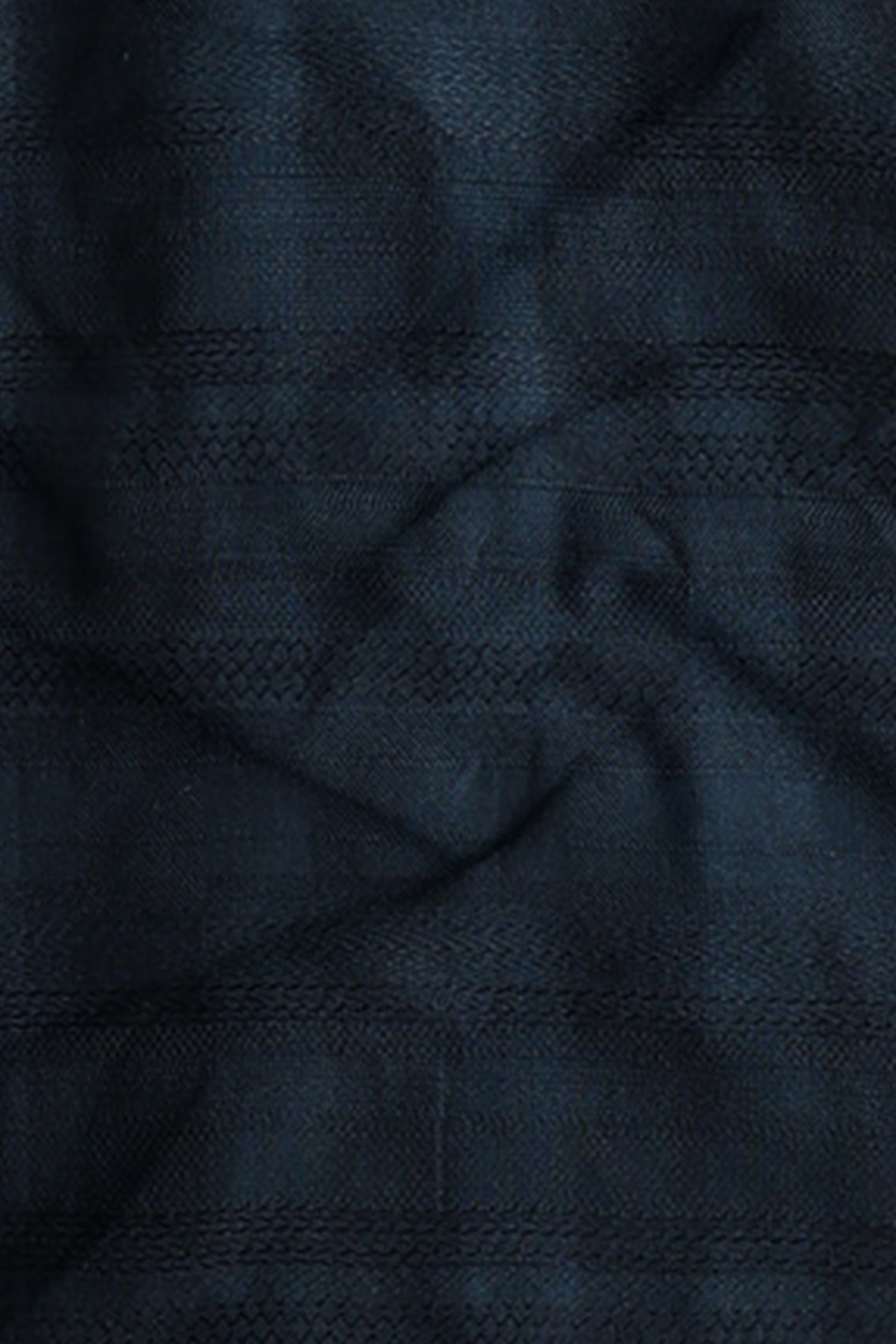 Close-up of dark blue fabric with a subtle pattern