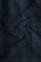 Close-up of dark blue fabric with a subtle pattern