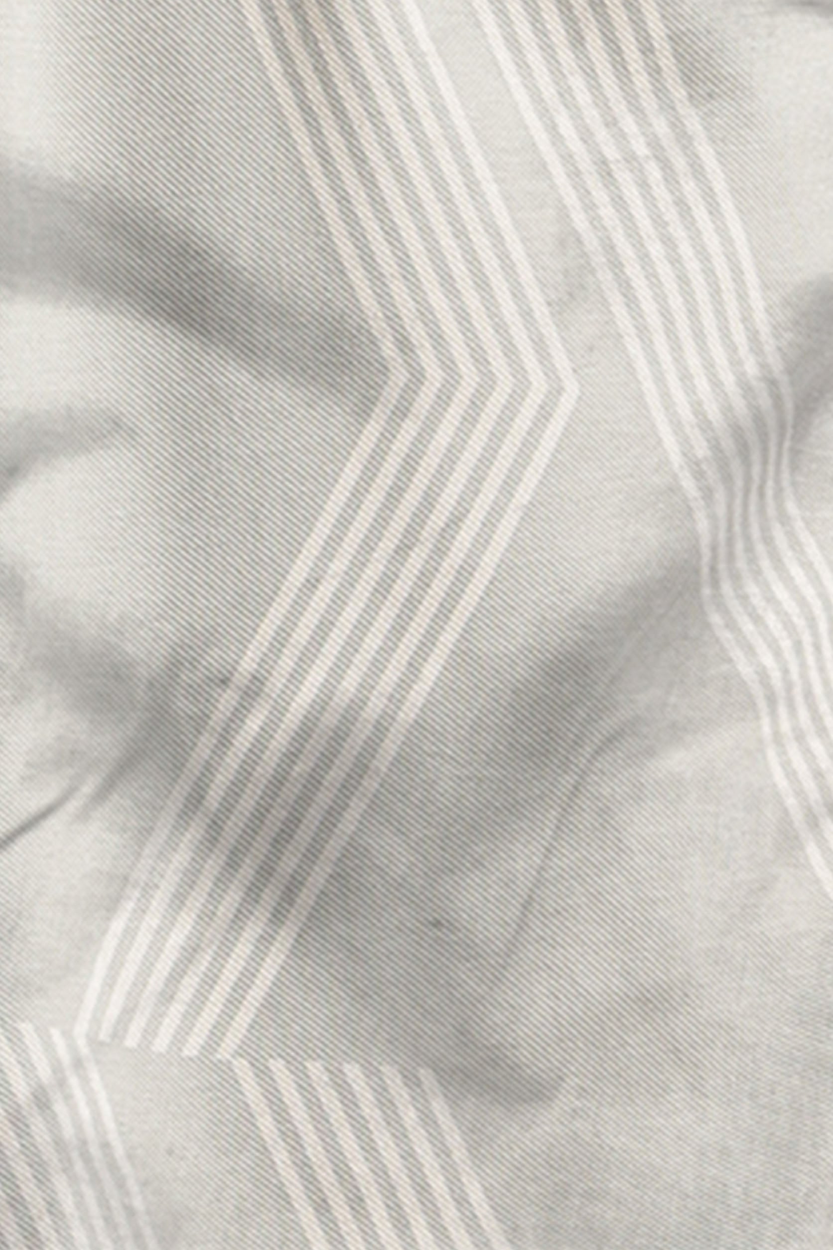 Close-up of fabric with a subtle pattern on a light gray background