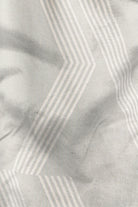 Close-up of fabric with a subtle pattern on a light gray background