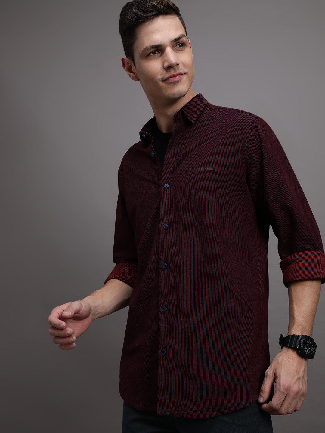 Man wearing a red red striped full sleeve 100% cotton shirt on a light gray background