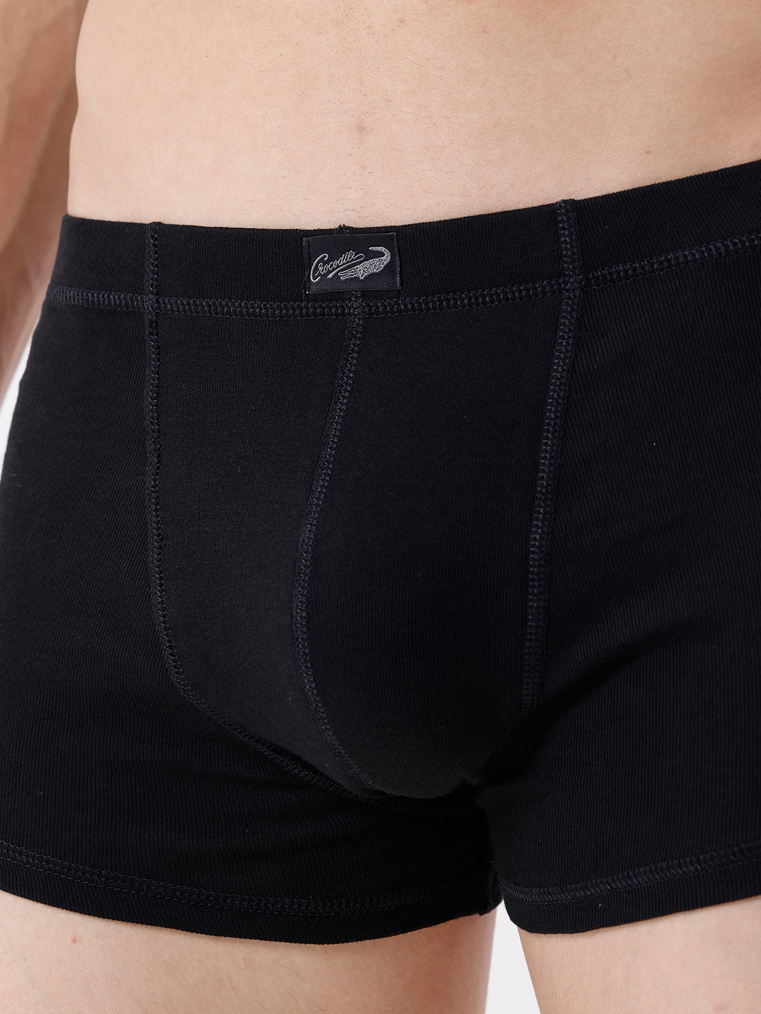 Black boxer briefs with a brand logo on a neutral background