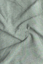 Close-up of textured green fabric with folds