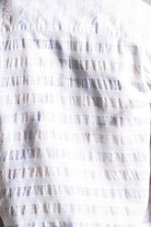 Close-up of a textured white fabric with a subtle pattern