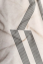 Close-up of a textured surface with black geometric patterns