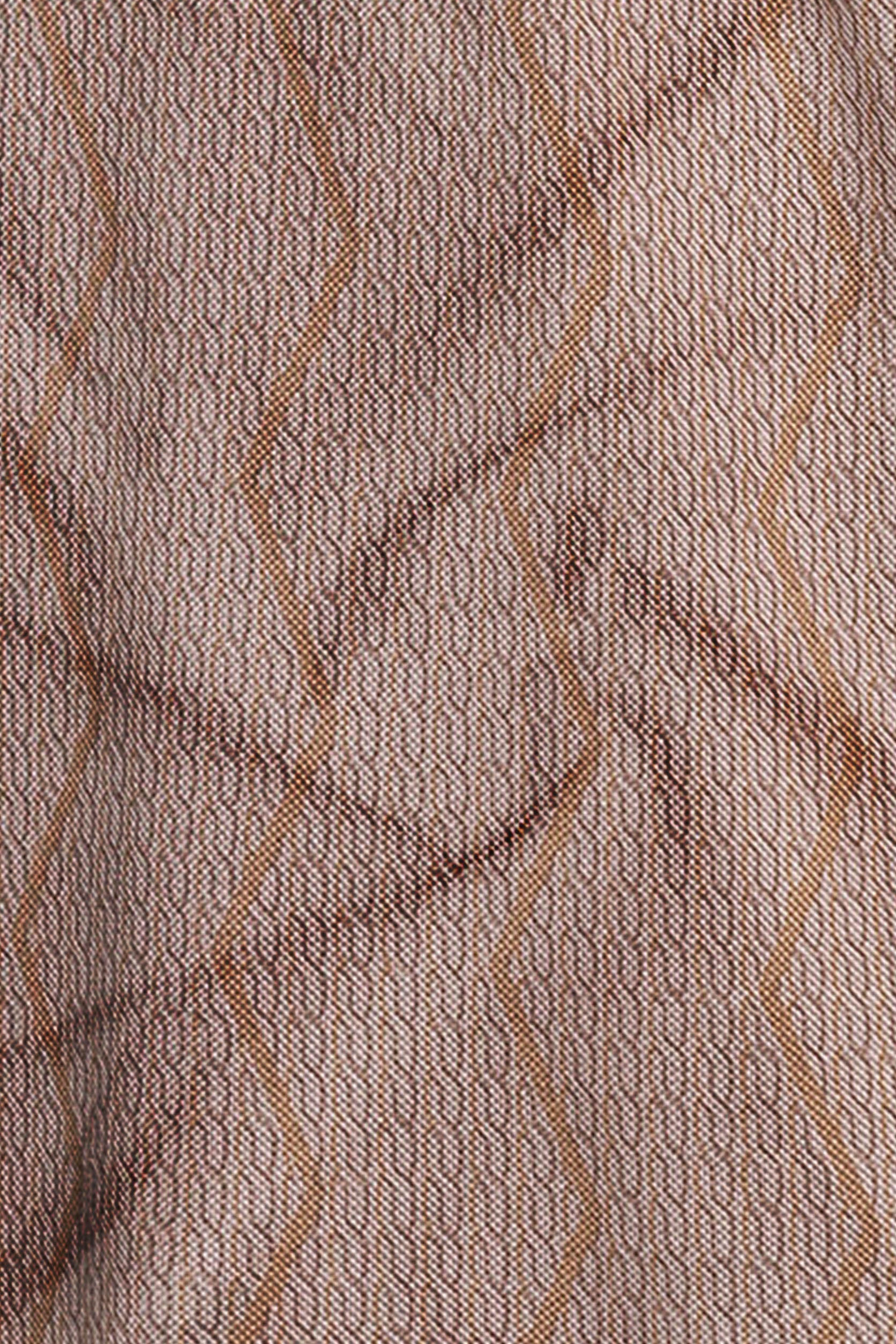 Close-up of a textured fabric with wavy lines in brown tones.