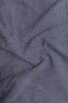 Close-up of textured blue fabric with folds