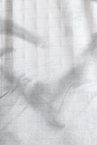 Textured white fabric with a subtle pattern