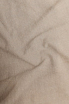Close-up of beige fabric with a subtle pattern