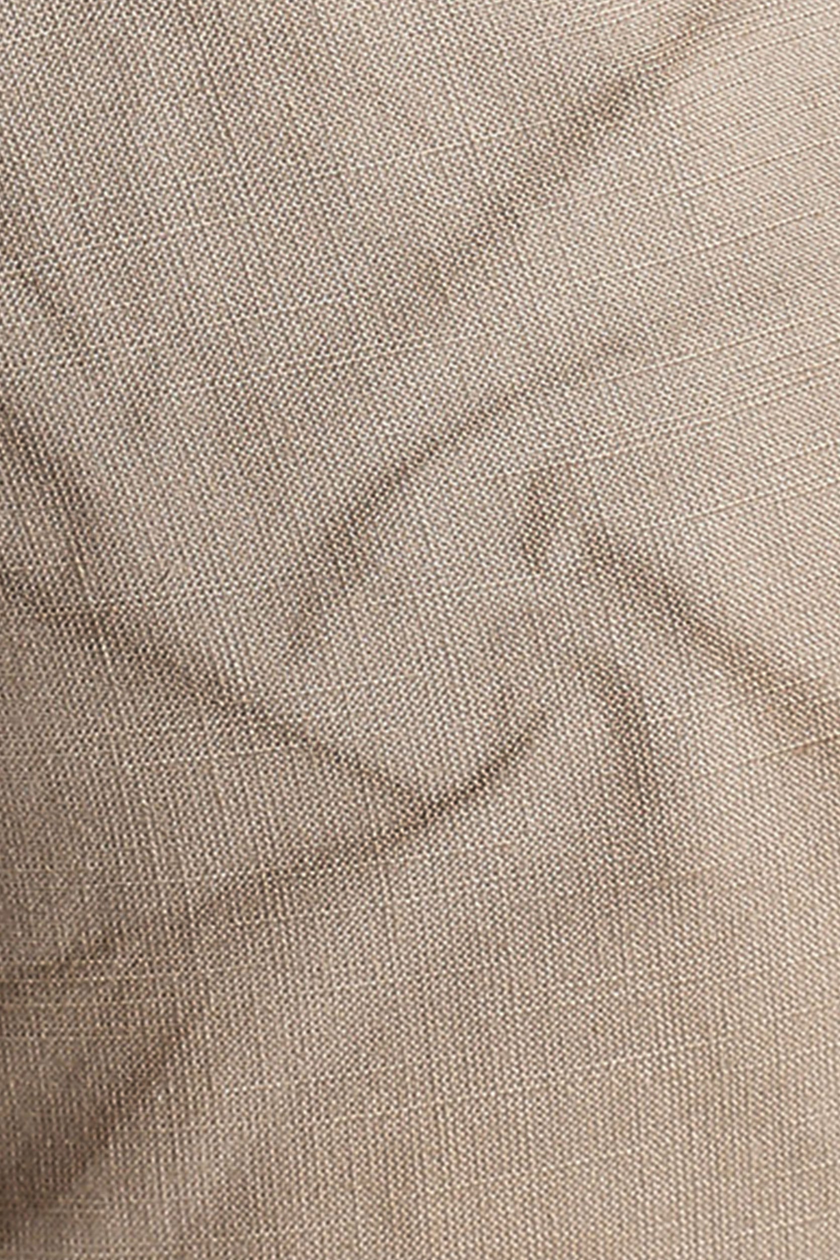 Close-up of beige fabric with a subtle pattern