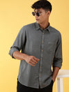 Man wearing a green green solid full sleeve casual 100% cotton shirt with casual styling on a gray background