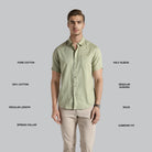 Man wearing a light green shirt with text describing features on a gray background