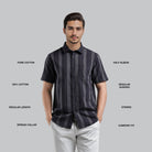 Man wearing a black striped shirt with text labels on a gray background