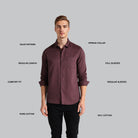 Man wearing a maroon shirt with text labels on a gray background