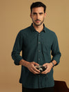 Man wearing a blue teal blue checked full sleeve 100% cotton shirt on a light gray background