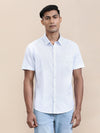 Man wearing a blue cool blue printed half sleeve shirt with casual styling on a gray background