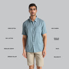 Man wearing a light blue shirt with text describing features on a gray background