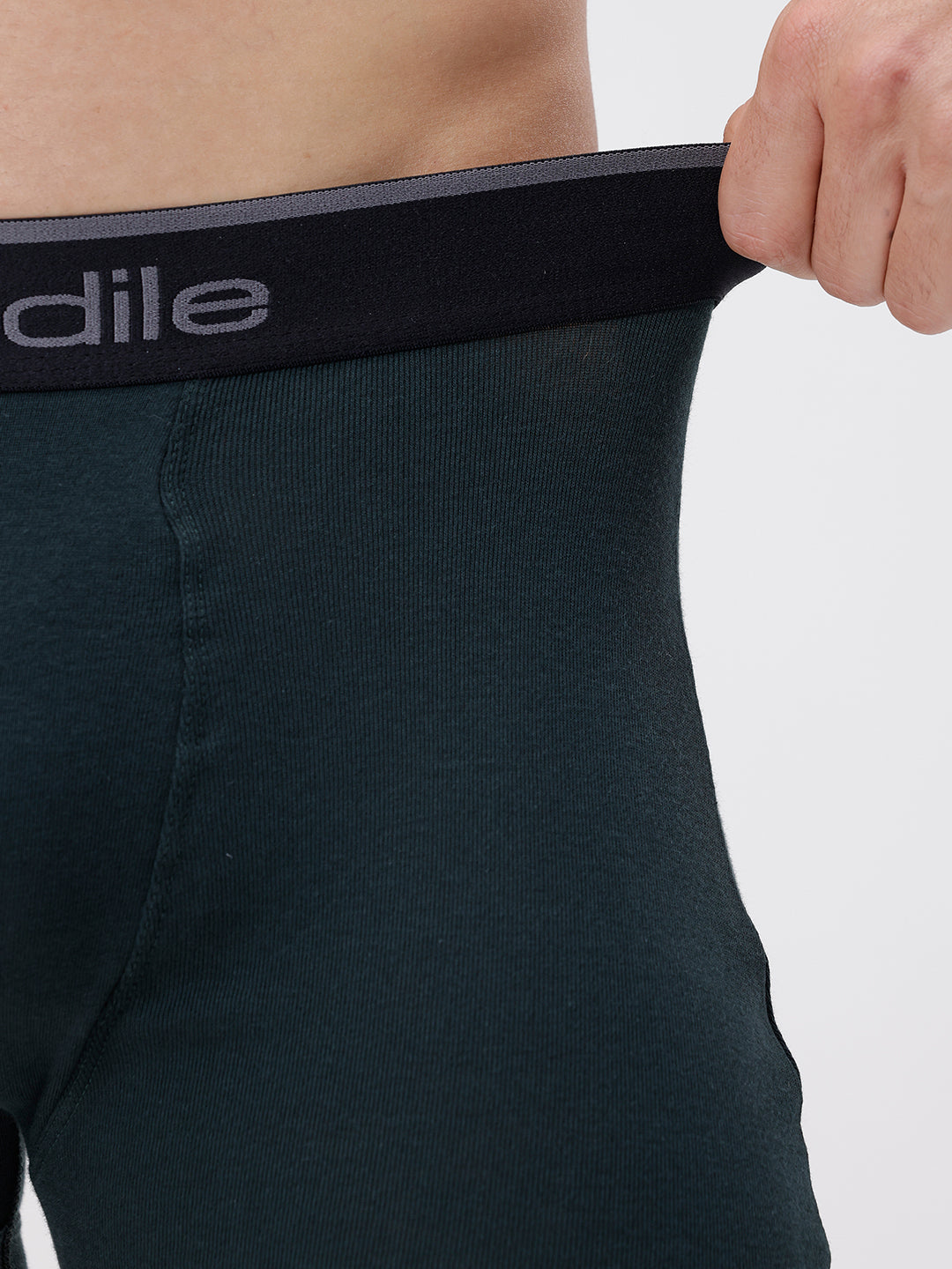 Person wearing a black underwear with 'Adile' branding on a white background