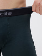 Person wearing a black underwear with 'Adile' branding on a white background