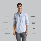 Man wearing a light blue shirt with text labels on a gray background