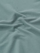 Man wearing a green iceberg green chest print slim fit polo t shirt on a light gray background