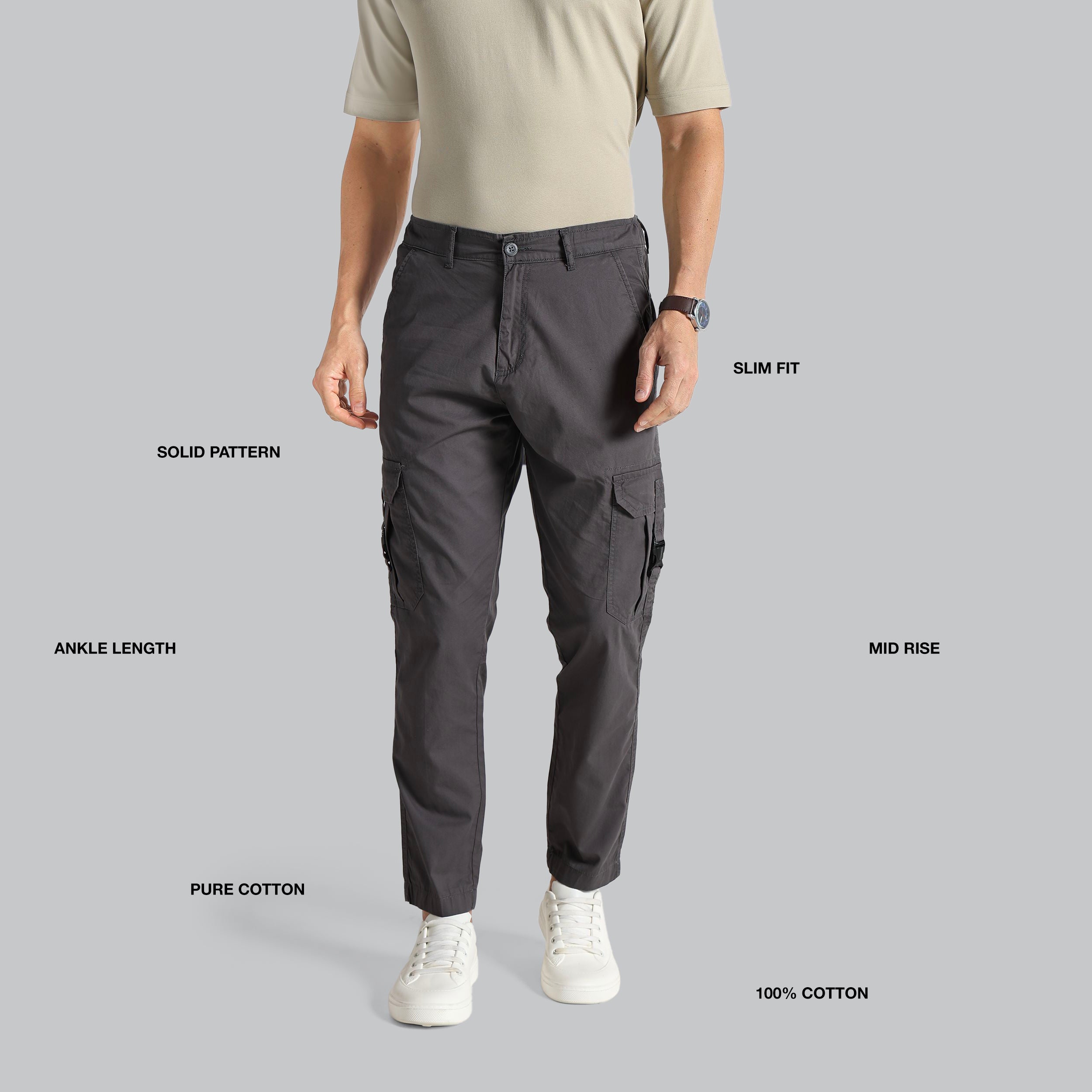 Person wearing gray cargo pants on a gray background with feature text.