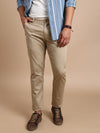 Man wearing a brown khaki brown printed slim fit casual trouser with casual styling on a gray background