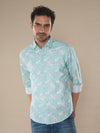 Man wearing a floral print pastel colour shirt mint on a light gray background