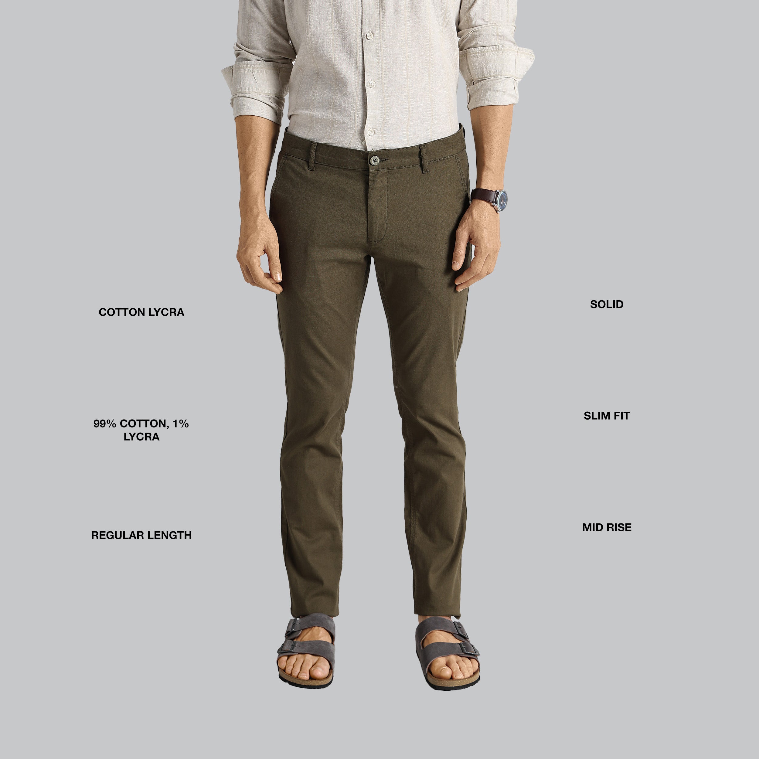 Person wearing brown pants with text detailing fabric composition, fit, and length on a gray background
