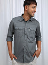 Man wearing a green green solid casual full sleeve shirt with casual styling on a gray background