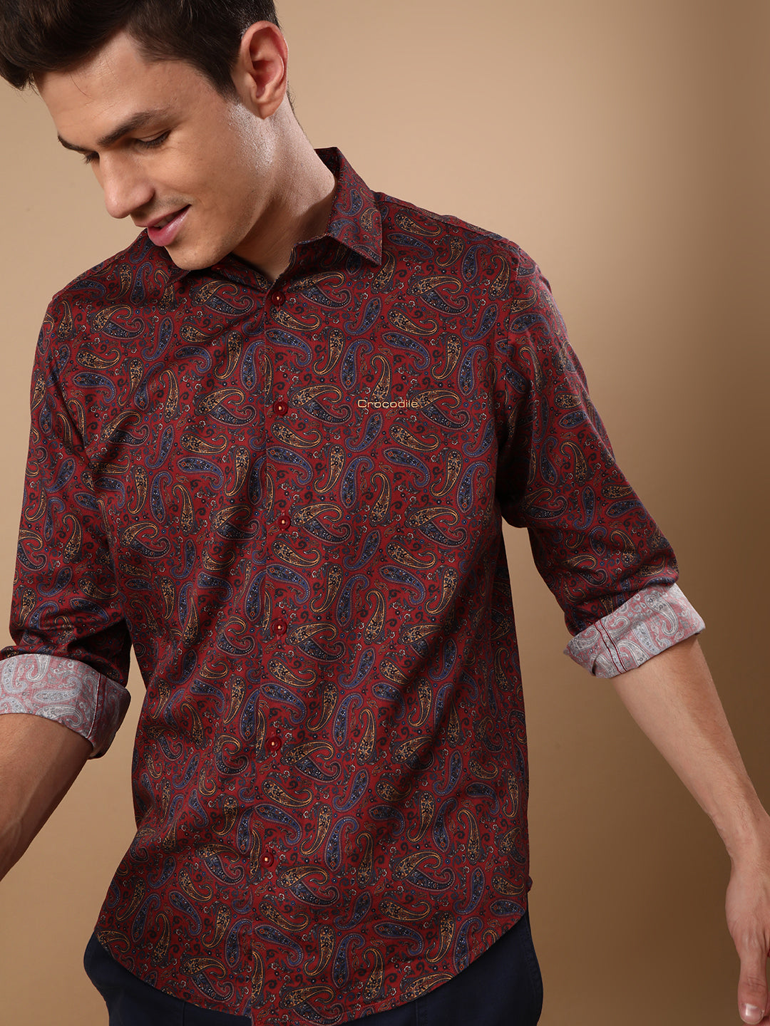 Man wearing a red red printed full sleeve 100% cotton shirt on a light gray background