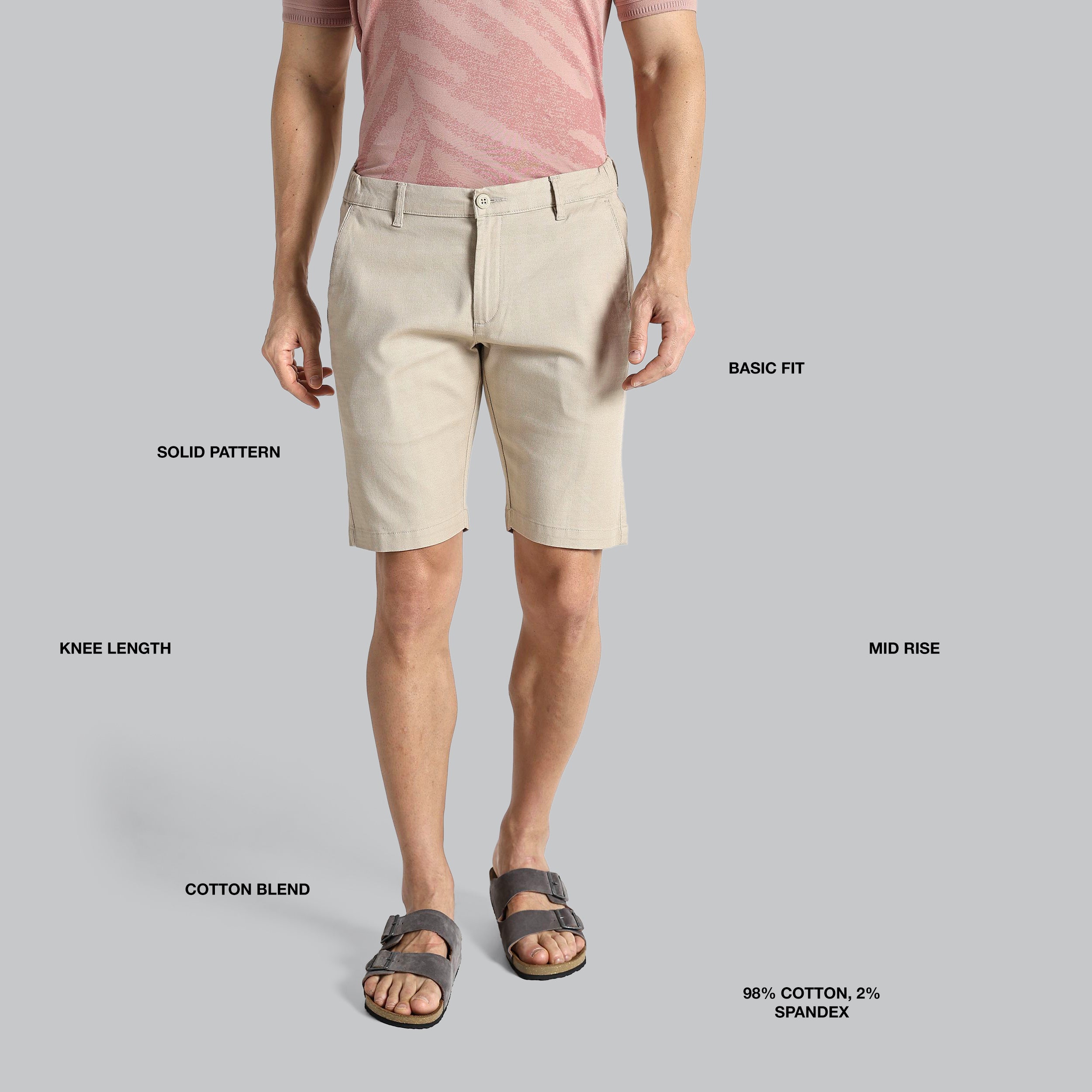 Beige shorts worn by a person on a gray background with text labels.