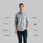 Man wearing a light gray shirt with text describing its features on a gray background