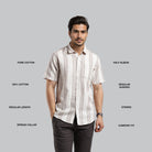 Man wearing a striped shirt with text describing garment features on a gray background