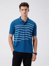Man wearing a green iceberg green chest print slim fit polo t shirt on a light gray background