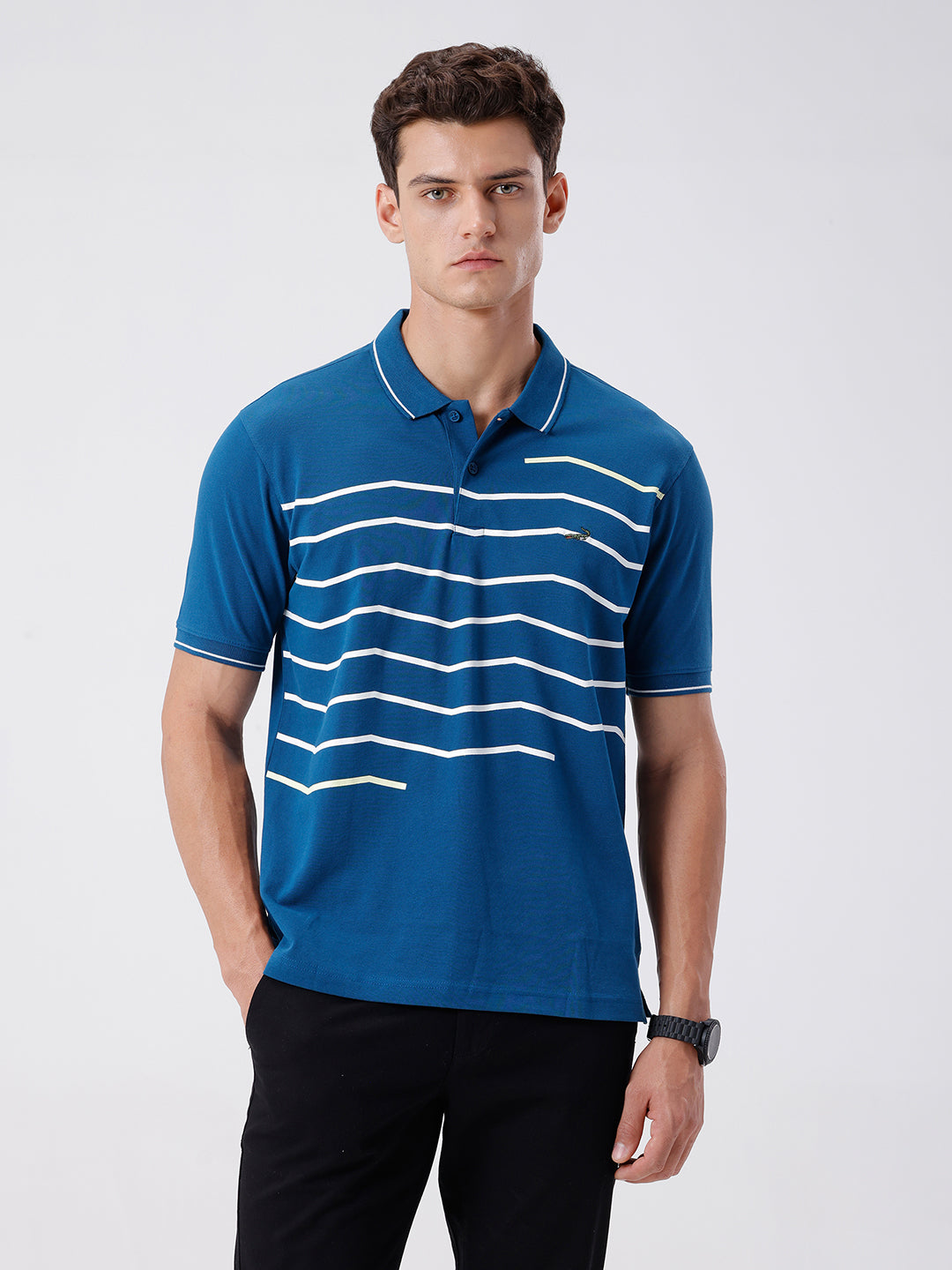 Man wearing a green iceberg green chest print slim fit polo t shirt on a light gray background