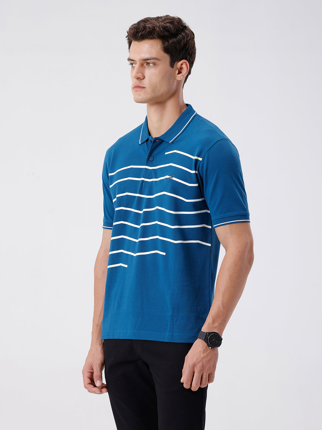 Man wearing a green iceberg green chest print slim fit polo t shirt on a light gray background